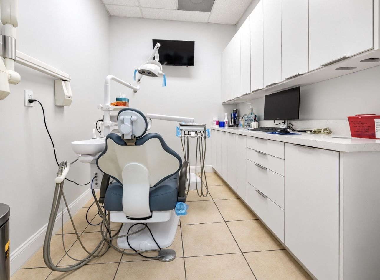 A bright treatment room with a modern dental chair